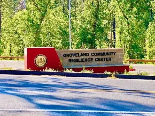 a front view of a house with a yard and potted plants