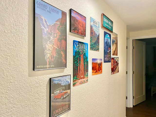 a view of a hallway with paintings on the wall