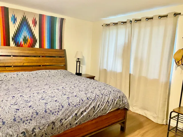 a bedroom with a bed and a window