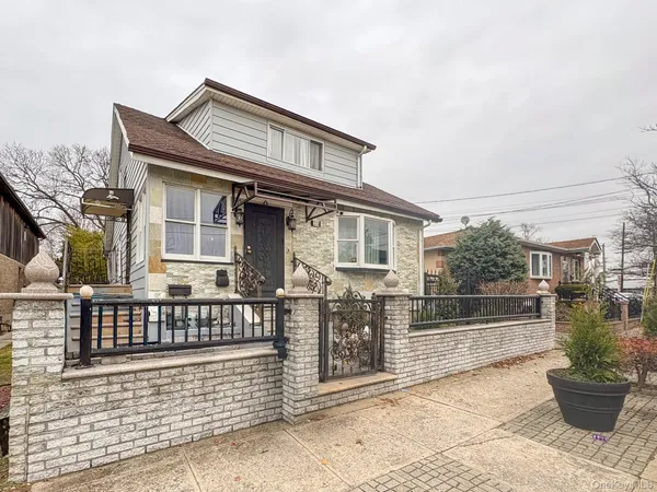a view of a house with a wooden fence