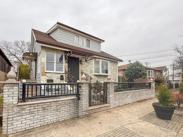 a view of a house with a wooden fence