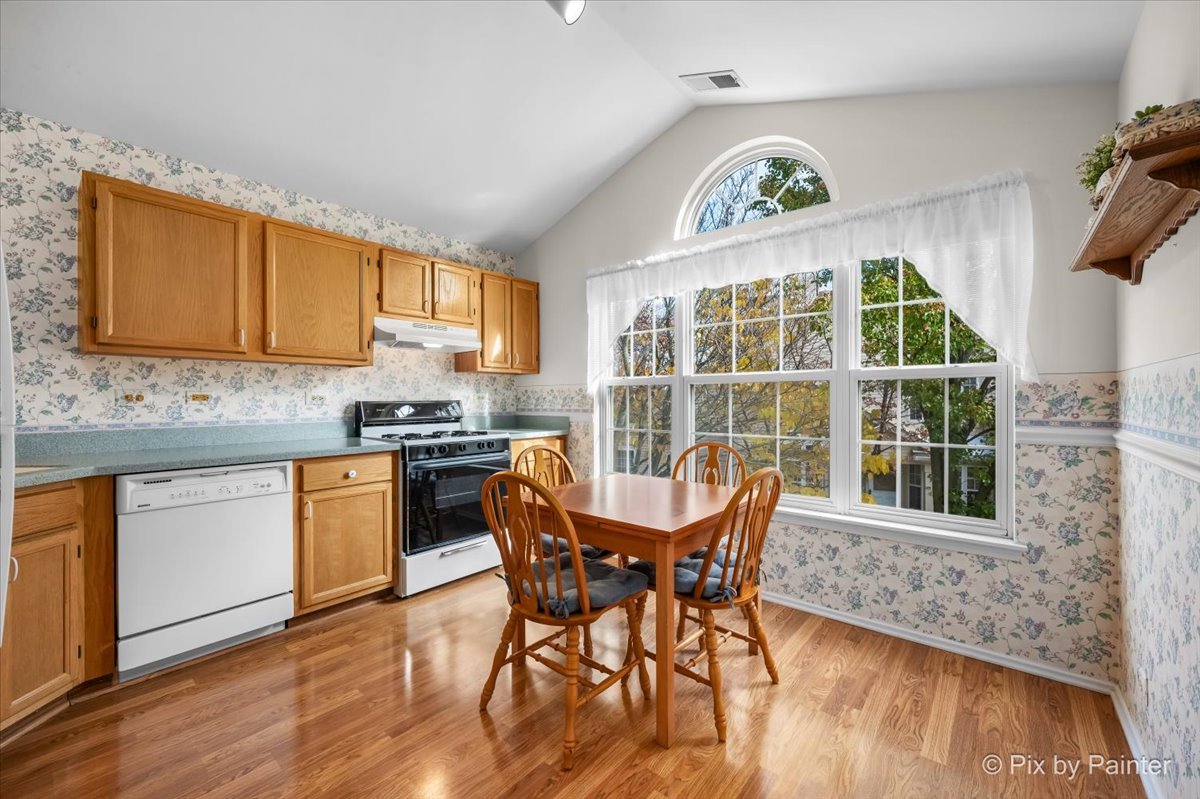 445 Cromwell Circle, Unit 3 Bartlett, IL 60103 - Photo 14 of 37 a dining room with a wooden floor and a window
