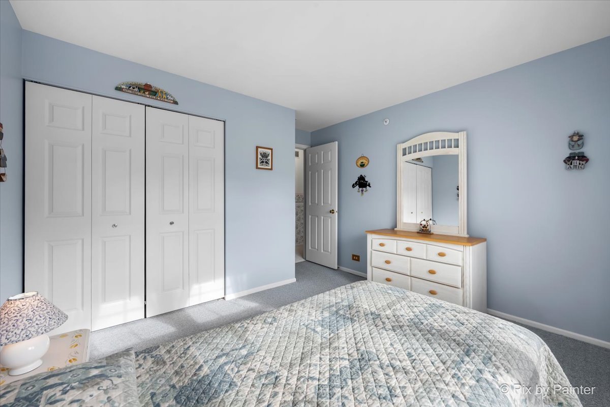 445 Cromwell Circle, Unit 3 Bartlett, IL 60103 - Photo 25 of 37 a bedroom with a bed and a dresser