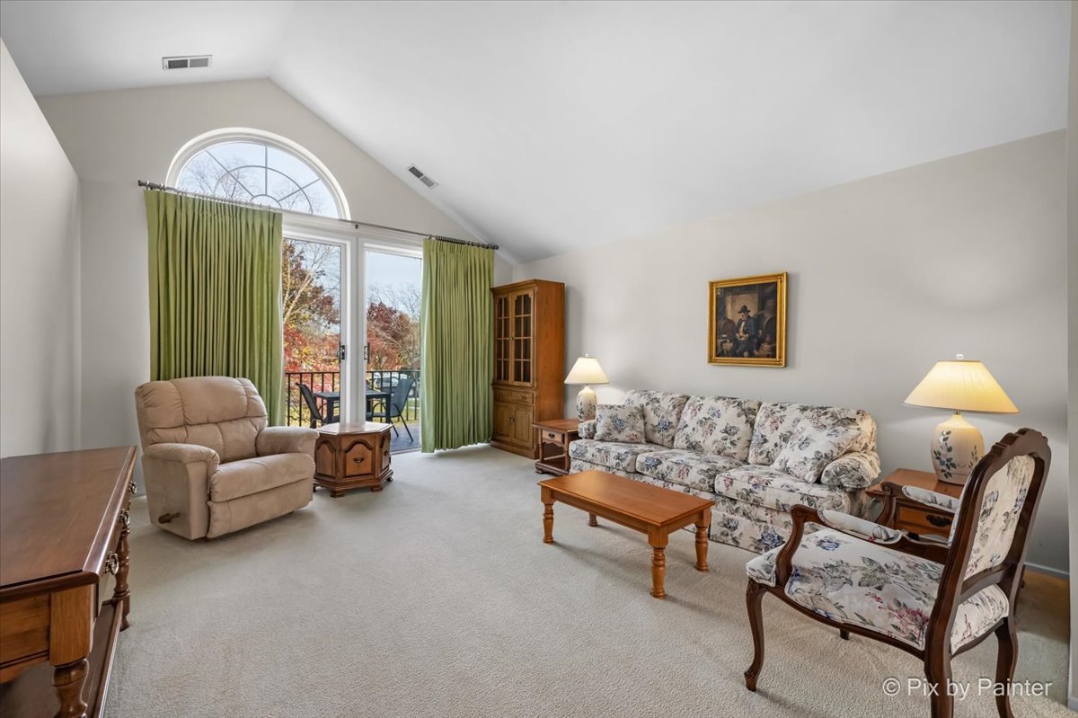 445 Cromwell Circle, Unit 3 Bartlett, IL 60103 - Photo 9 of 37 a living room with furniture and a large window