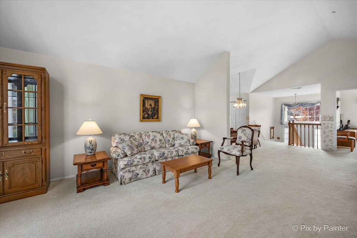 445 Cromwell Circle, Unit 3 Bartlett, IL 60103 - Photo 10 of 37 a living room with furniture and a lamp