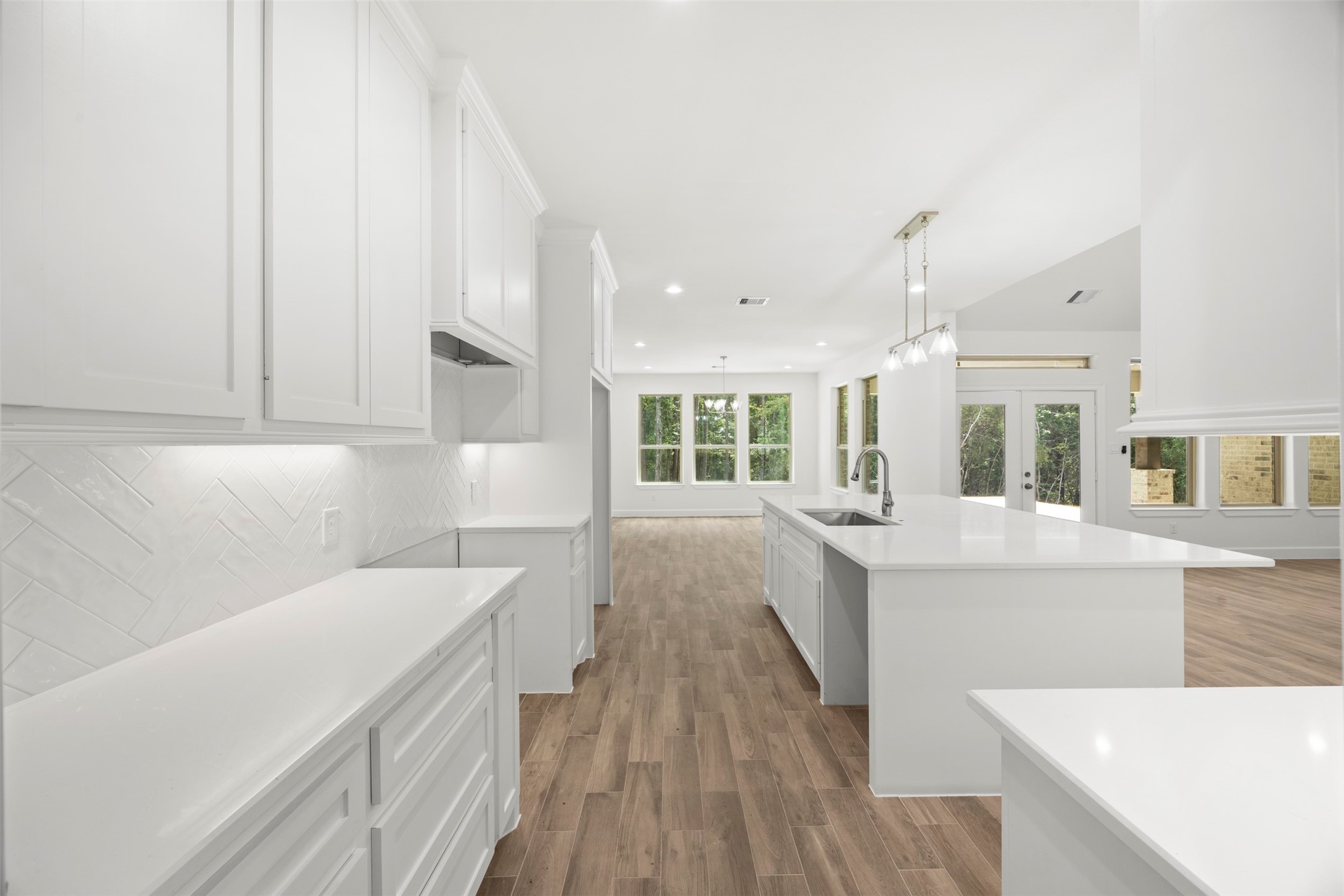 183 Windmill Road Huntsville, TX 77340 - Photo 14 of 47 Tall ceilings throughout with kitchen cabinets to the ceiling.