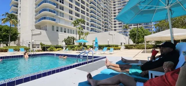 a view of swimming pool with outdoor seating and plants
