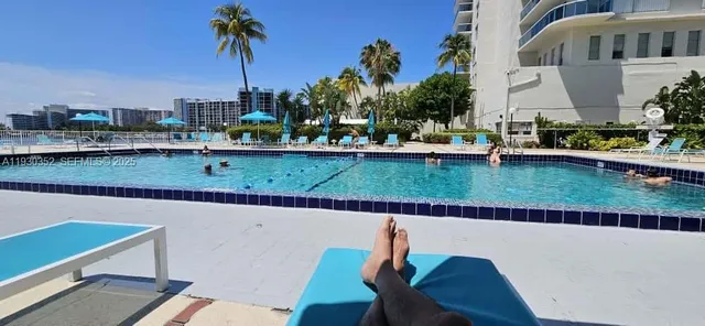 an aerial view of a house with a garden and lake view