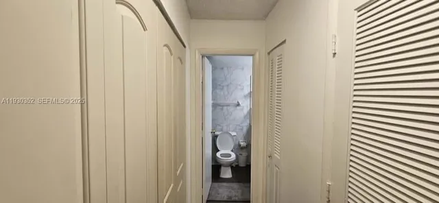 a view of a bathroom from a hallway