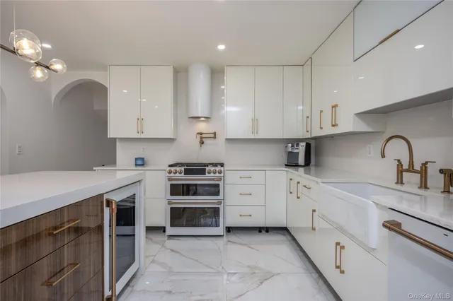 a kitchen with stainless steel appliances granite countertop a sink stove and cabinets