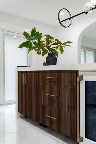a vase of flowers sitting on a table in front of a door