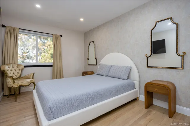 a bedroom with a bed chair and window