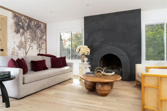 a living room with furniture a fireplace and a table