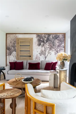 a living room with furniture and a potted plant