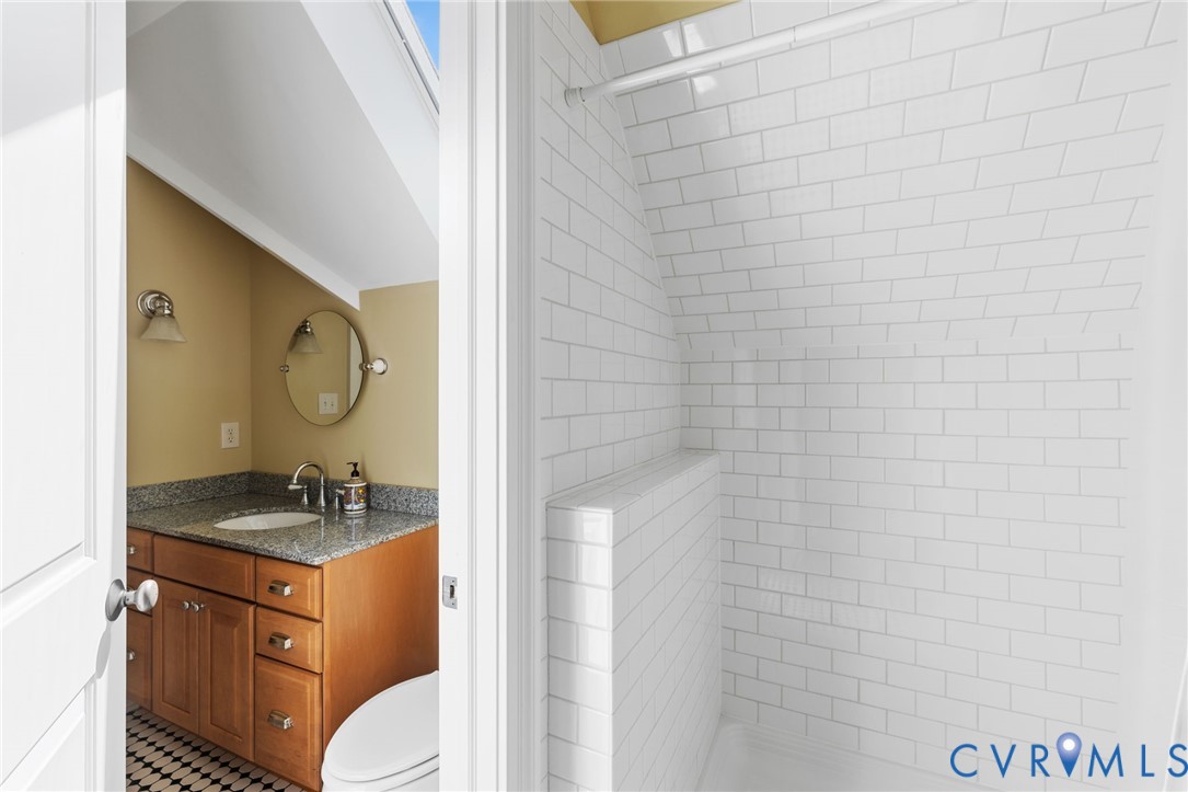8947 Cherokee Road Richmond, VA 23235 - Photo 38 of 45 a bathroom with a granite countertop sink and a mirror