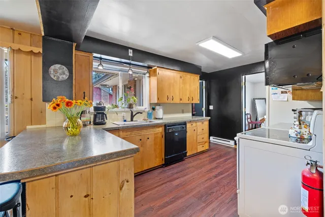a kitchen with stainless steel appliances a stove top oven
