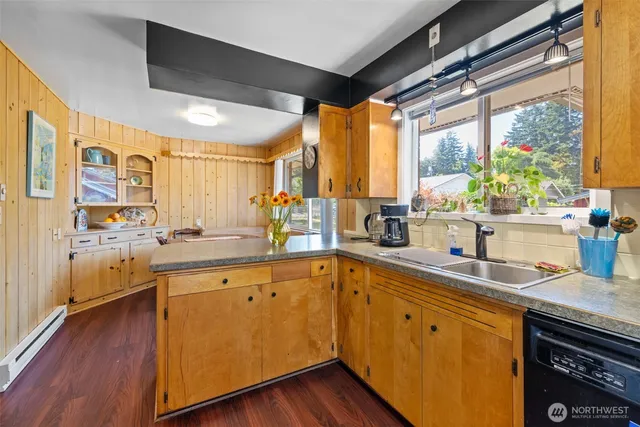 a kitchen with sink cabinets and wooden floor