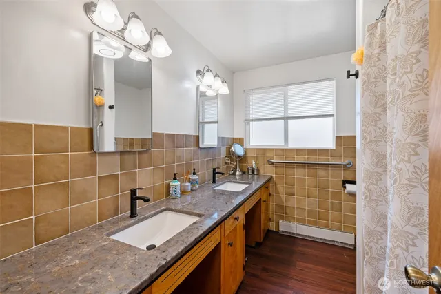 a bathroom with a granite countertop shower and a sink