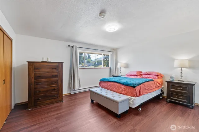 a bedroom with a bed and cabinet