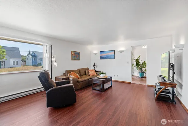a living room with furniture and a wooden floor