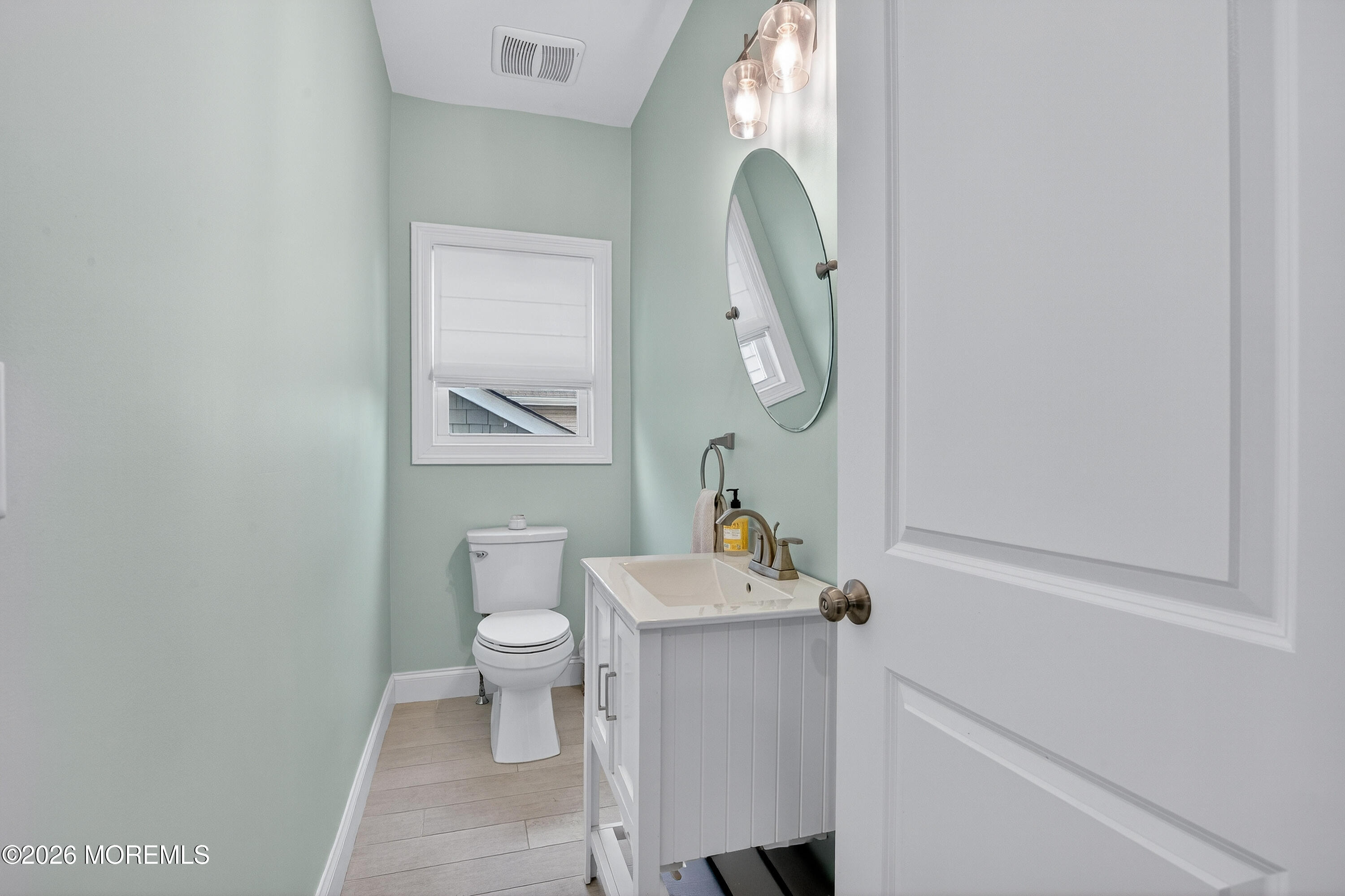 27 5th Street Highlands, NJ 07732 - Photo 30 of 62 a bathroom with a sink toilet and a mirror