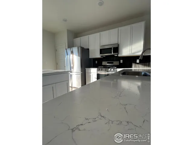 a view of a kitchen with electric appliances