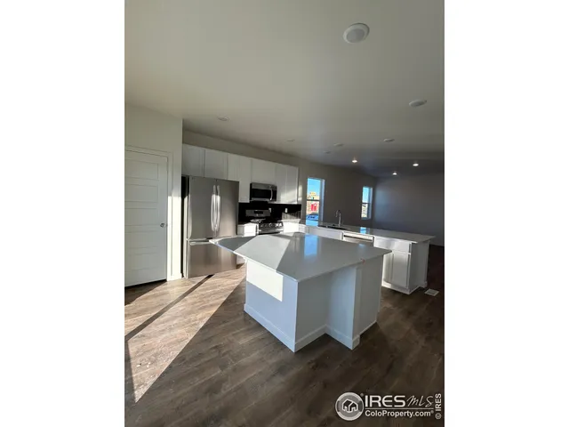 a living room with a couch and a dining table with wooden floor