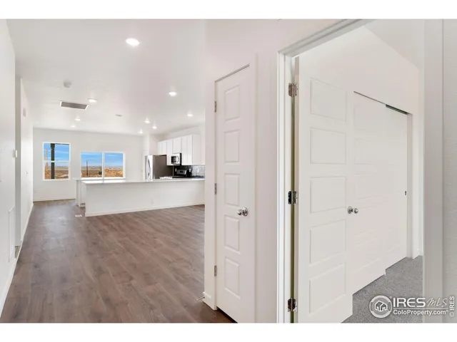a view of a kitchen with wooden floor and a kitchen