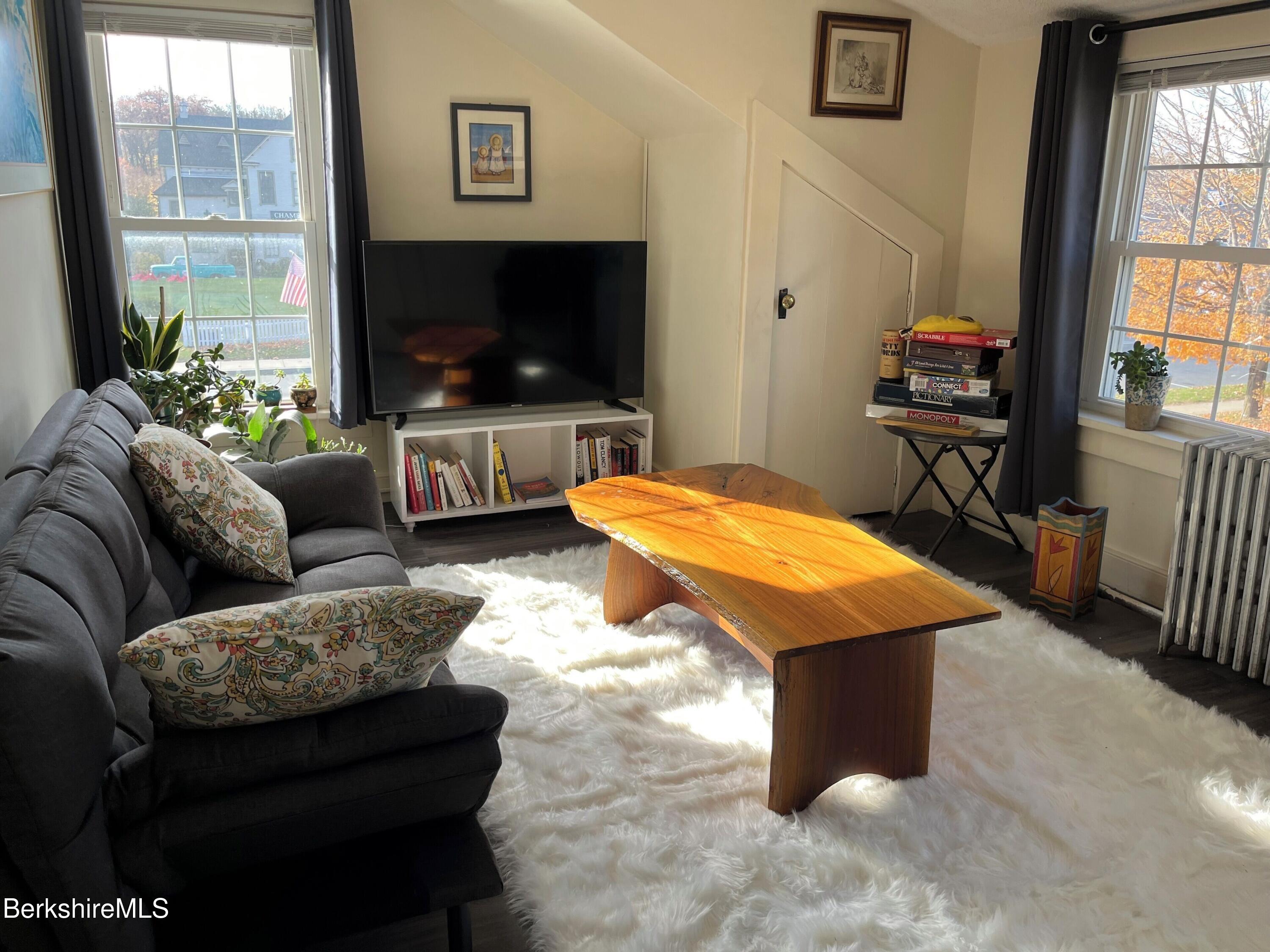 208 Main Street Lee, MA 01238 - Photo 11 of 29 a living room with furniture and a flat screen tv