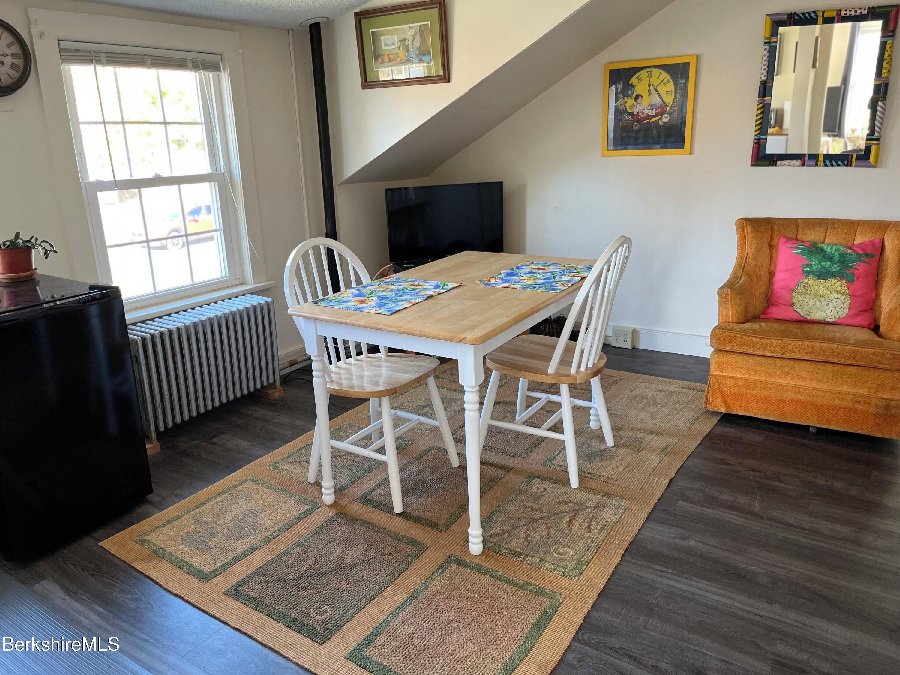 208 Main Street Lee, MA 01238 - Photo 12 of 29 a view of a dining room with furniture and wooden floor