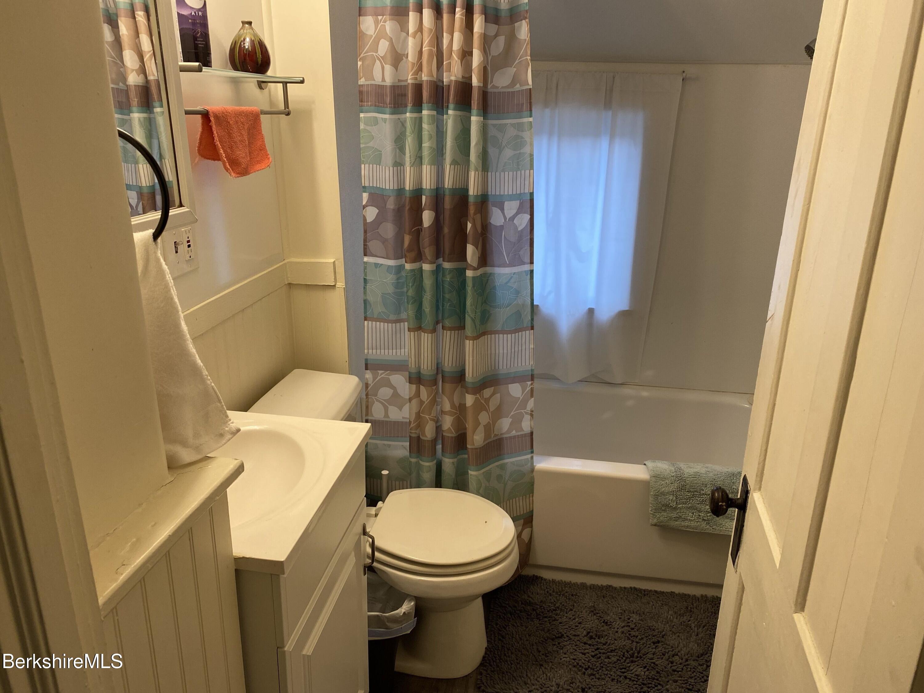 208 Main Street Lee, MA 01238 - Photo 13 of 29 a white toilet sitting next to a bathroom sink