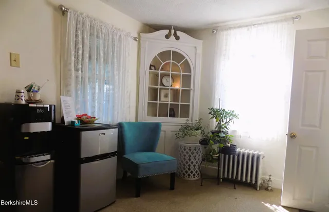 a bedroom with a bed and a potted plant