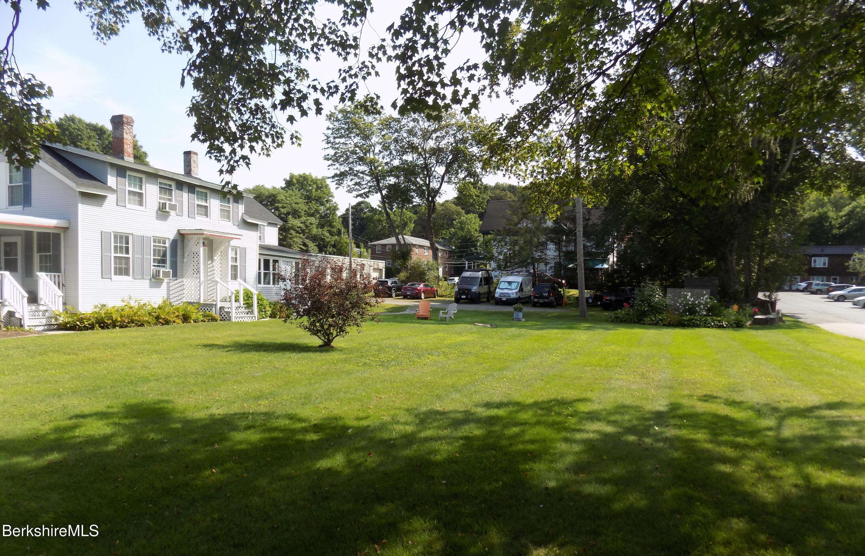 208 Main Street Lee, MA 01238 - Photo 24 of 29 a view of a house with a big yard and large trees