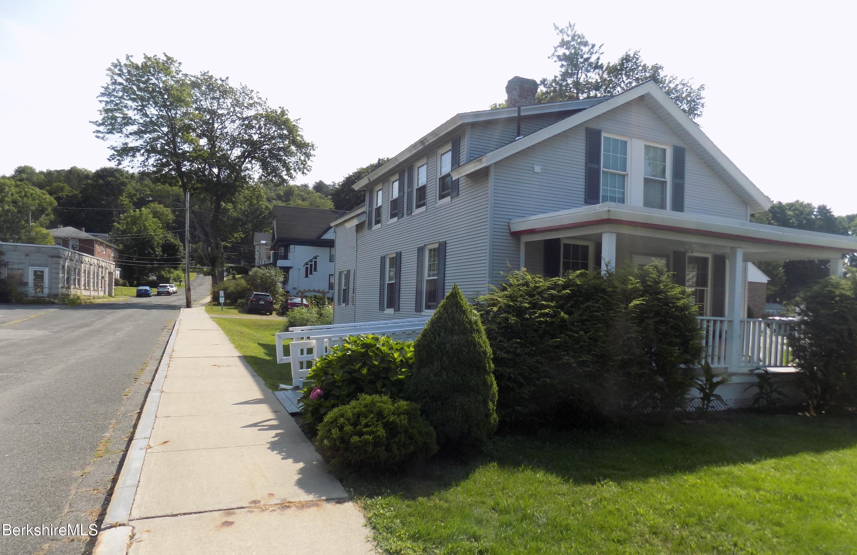 208 Main Street Lee, MA 01238 - Photo 29 of 29 a view of a house with sitting area and garden