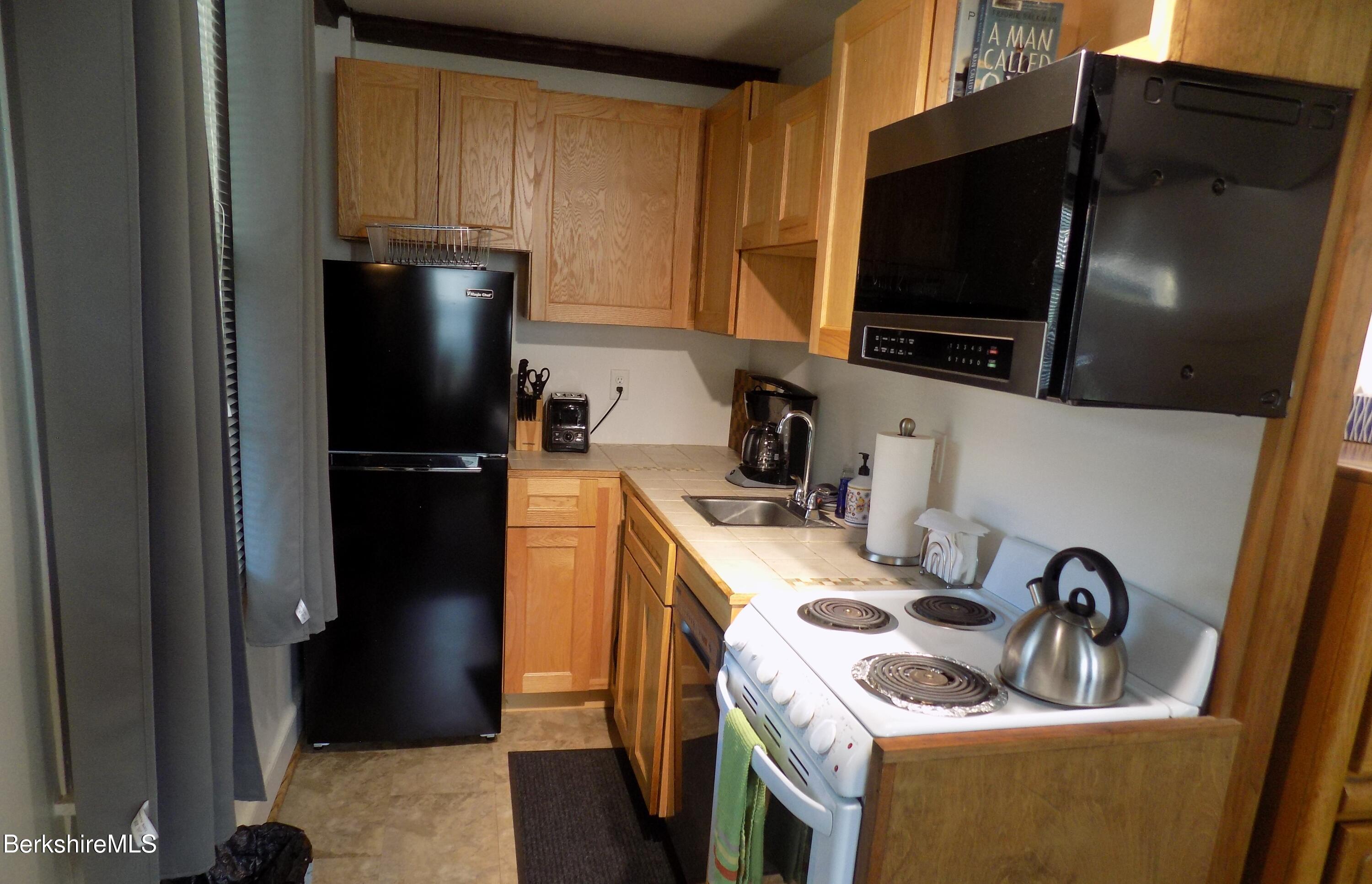 208 Main Street Lee, MA 01238 - Photo 3 of 29 a kitchen with a refrigerator stove and sink