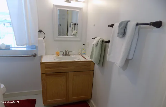 a bathroom with a sink and mirror