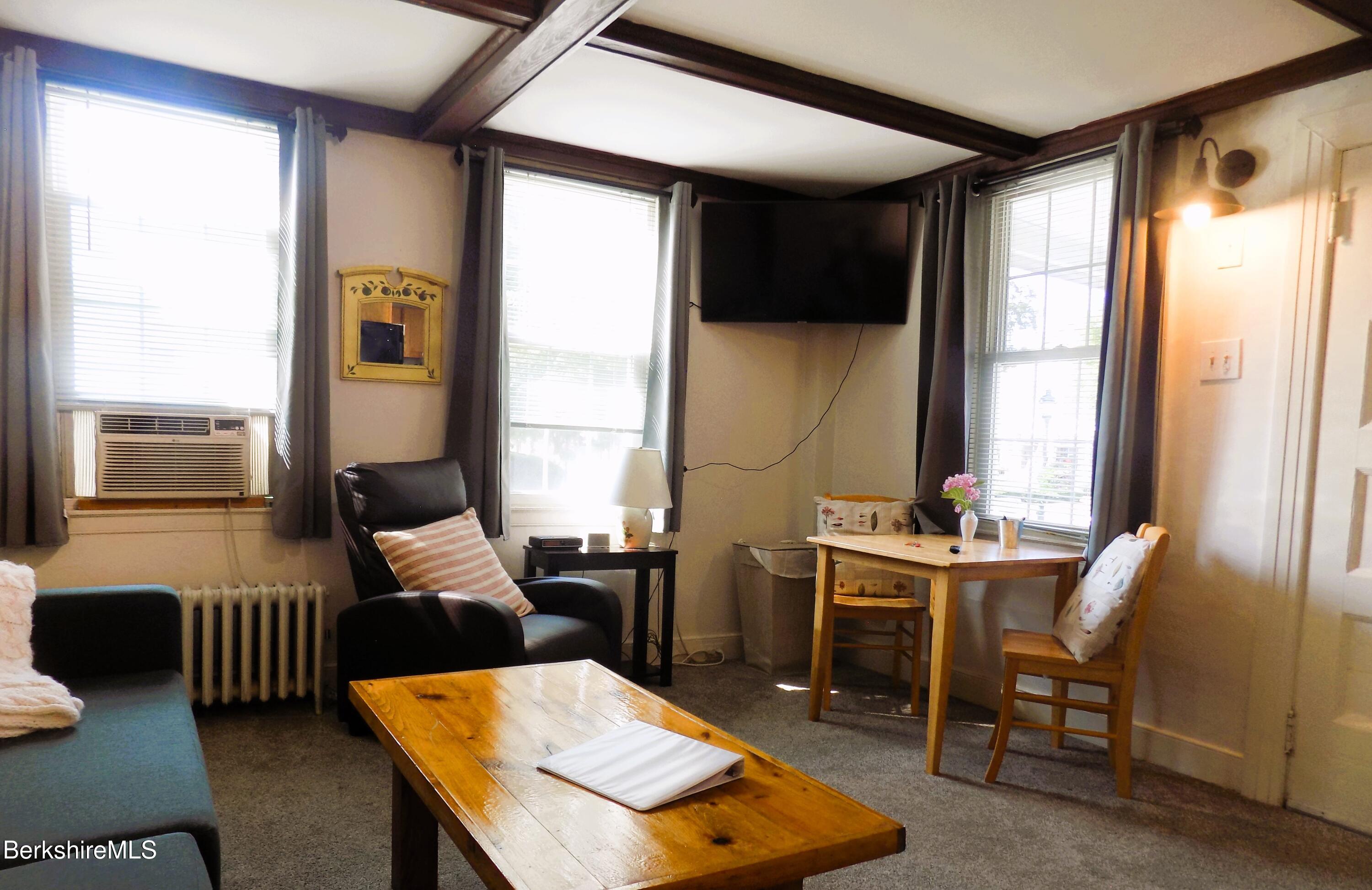 208 Main Street Lee, MA 01238 - Photo 5 of 29 a living room with furniture and a window