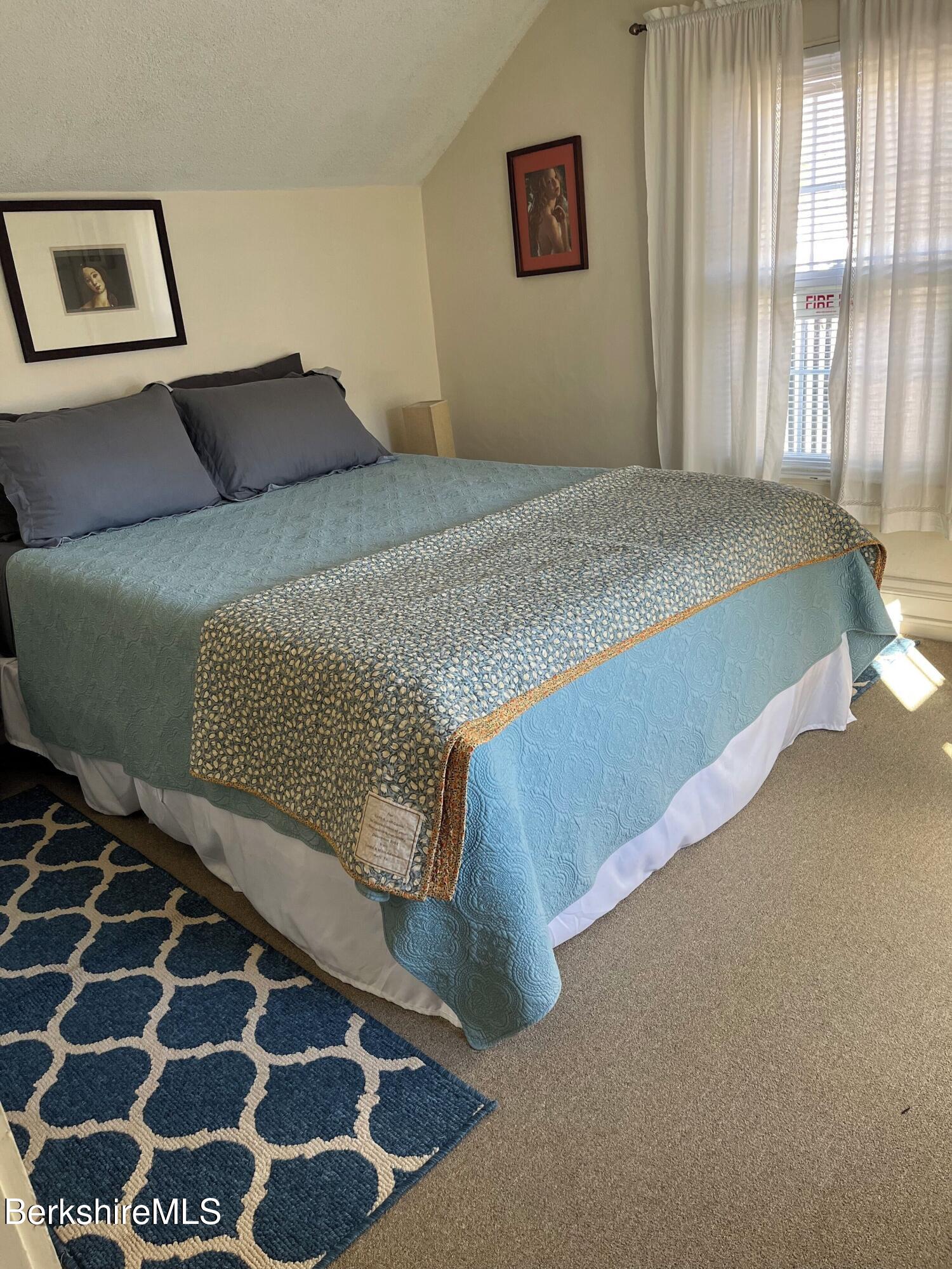 208 Main Street Lee, MA 01238 - Photo 9 of 29 a bedroom with a bed and wooden floor