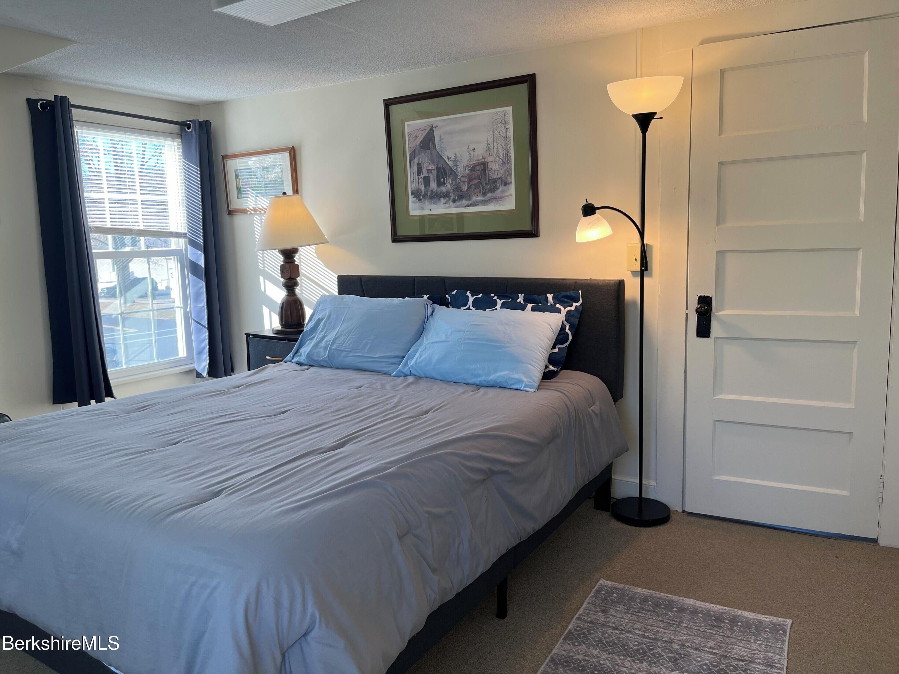 208 Main Street Lee, MA 01238 - Photo 10 of 29 a bedroom with a bed and a window