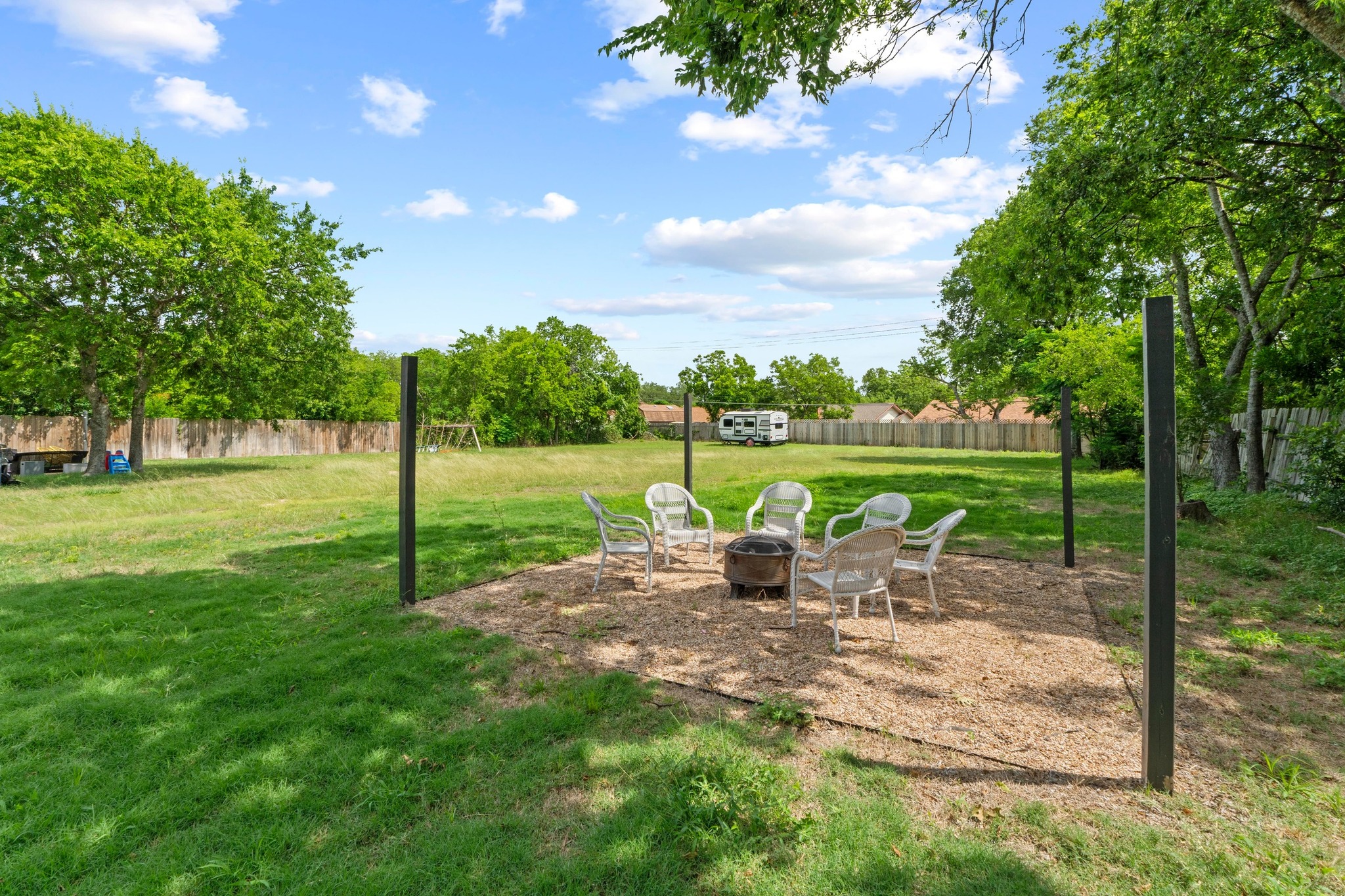 10601 Macmora Road, Unit B Austin, TX 78758 - Photo 18 of 22 A spacious yard features a dedicated gravel area with a fire pit, perfect for outdoor gatherings.