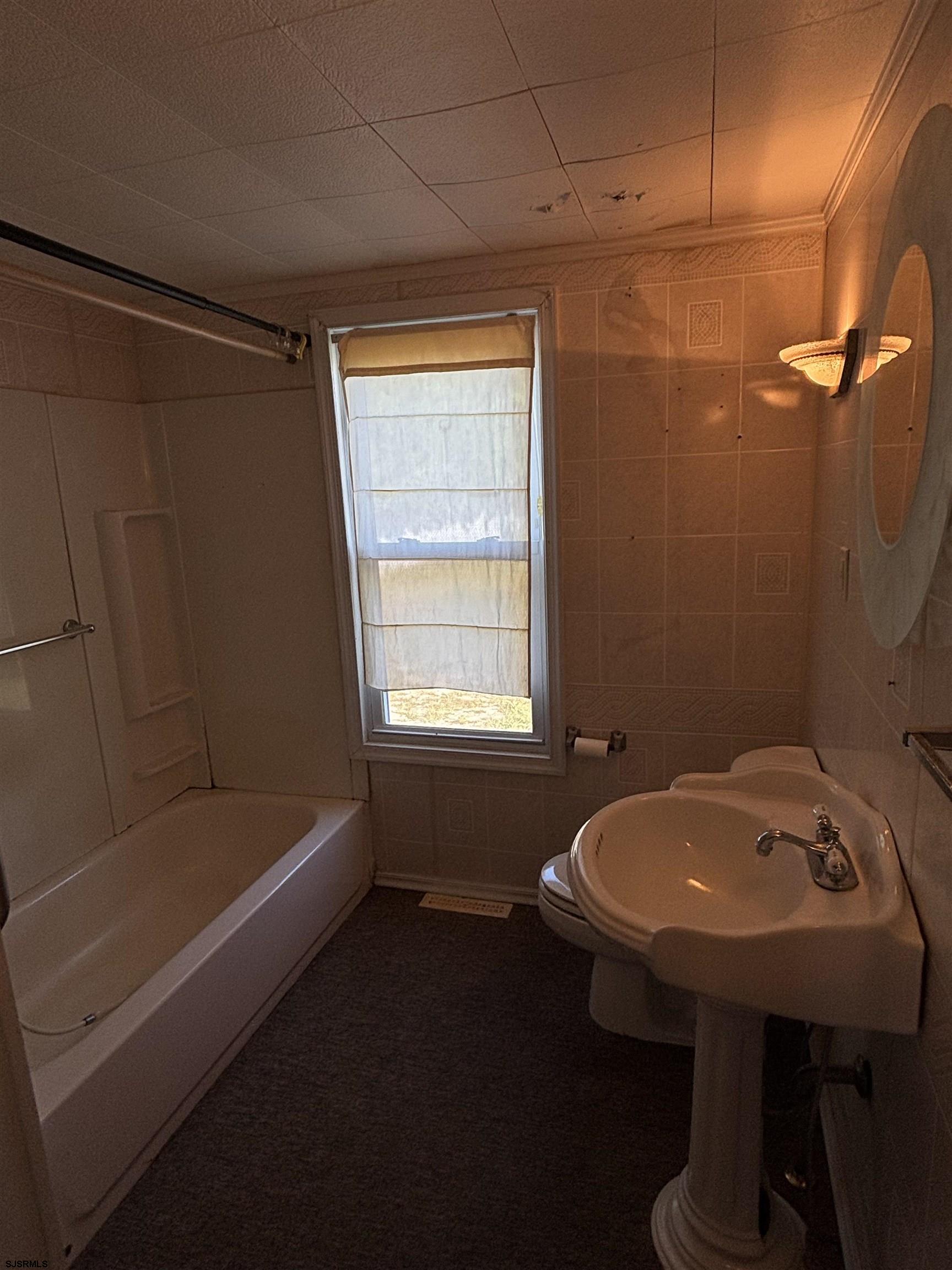 1233 Highway 9 Ocean View, NJ 08230 - Photo 19 of 33 a bathroom with a sink and a bathtub