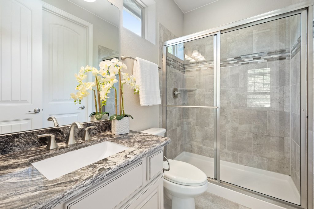 108 Berry Cove Georgetown, TX 78628 - Photo 21 of 39 a bathroom with a granite countertop sink toilet and shower