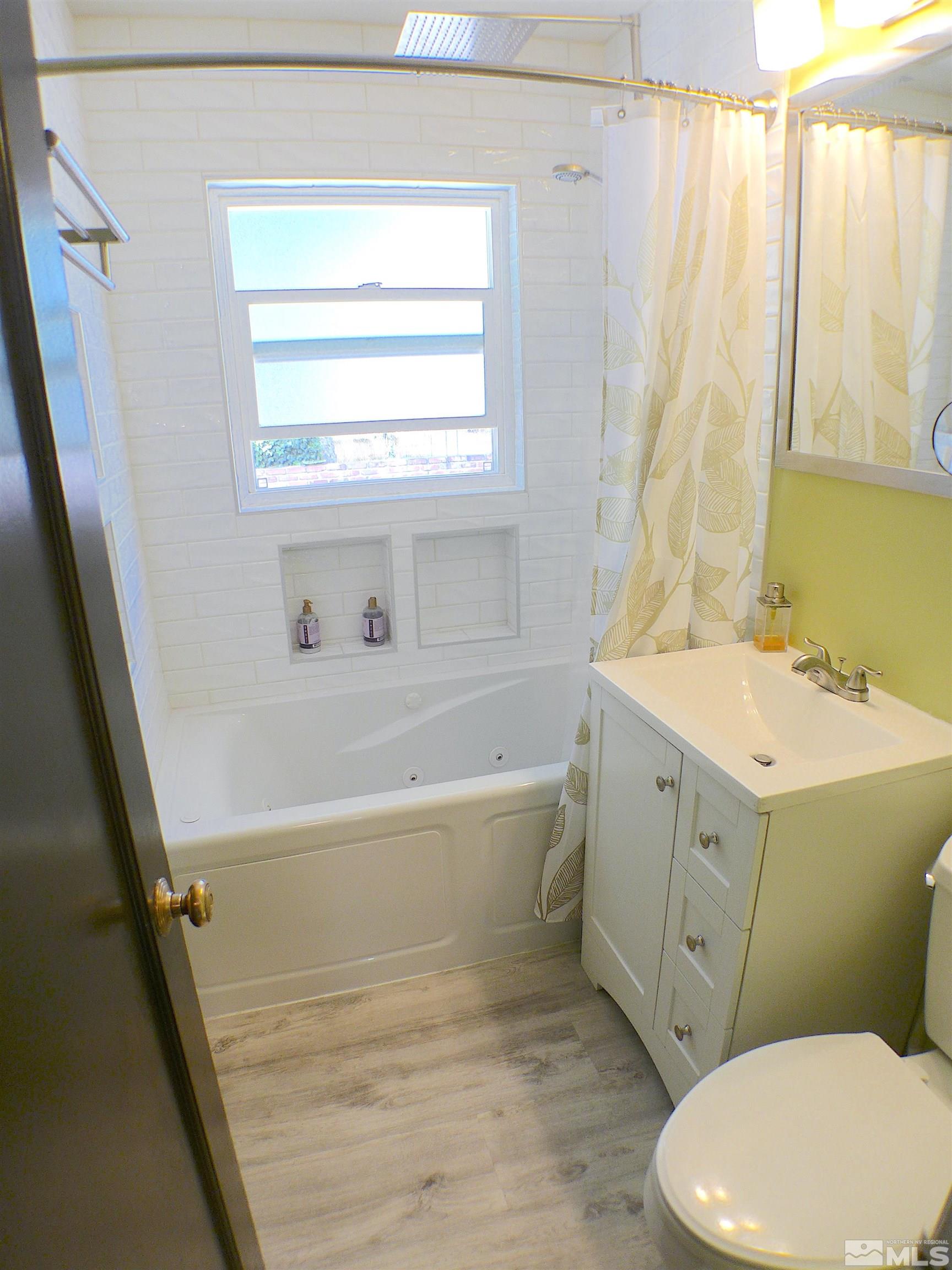 925 Yori Avenue Reno, NV 89502 - Photo 11 of 20 a bathroom with a sink toilet and window