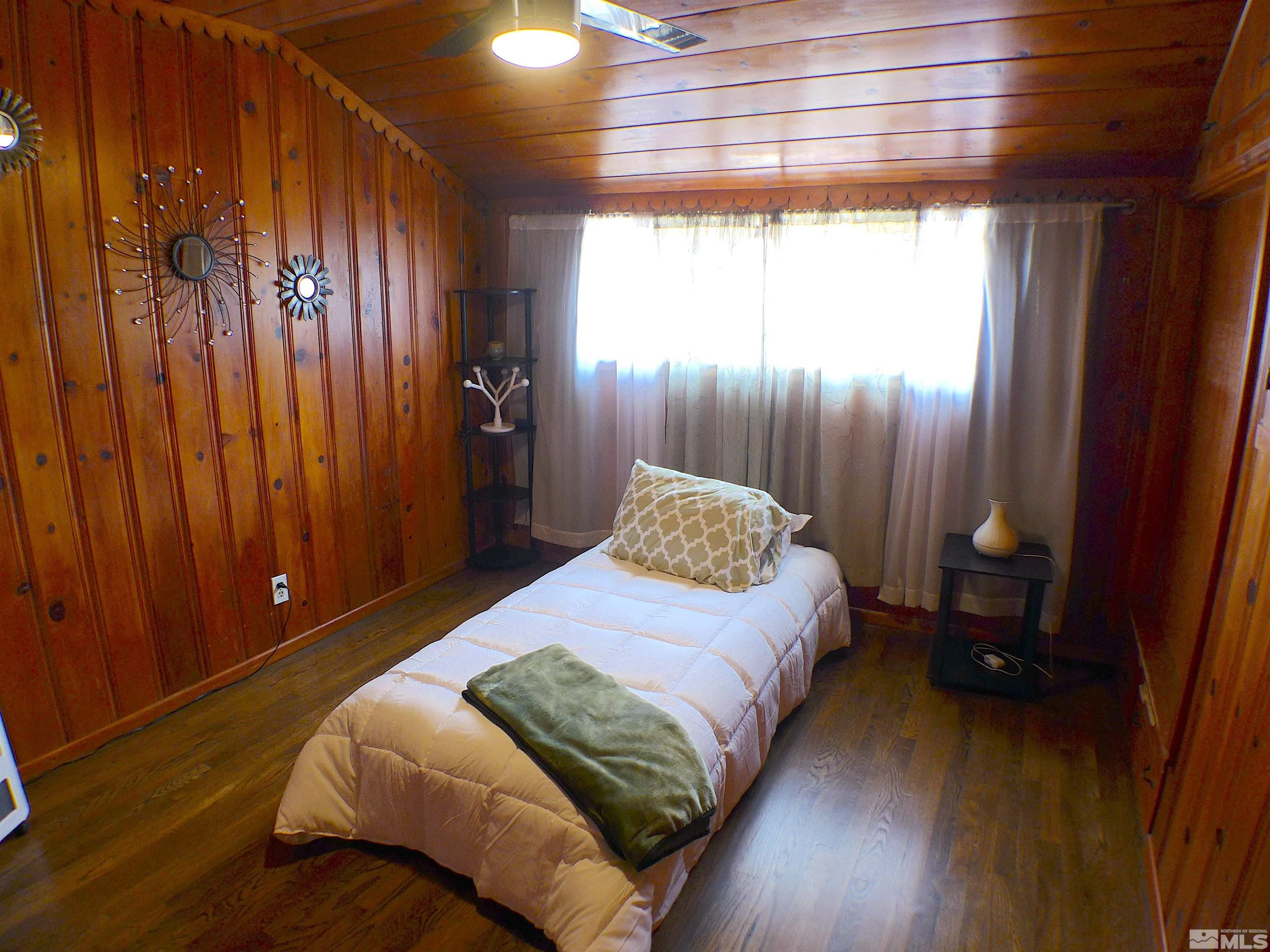 925 Yori Avenue Reno, NV 89502 - Photo 12 of 20 a bedroom with a bed and a window