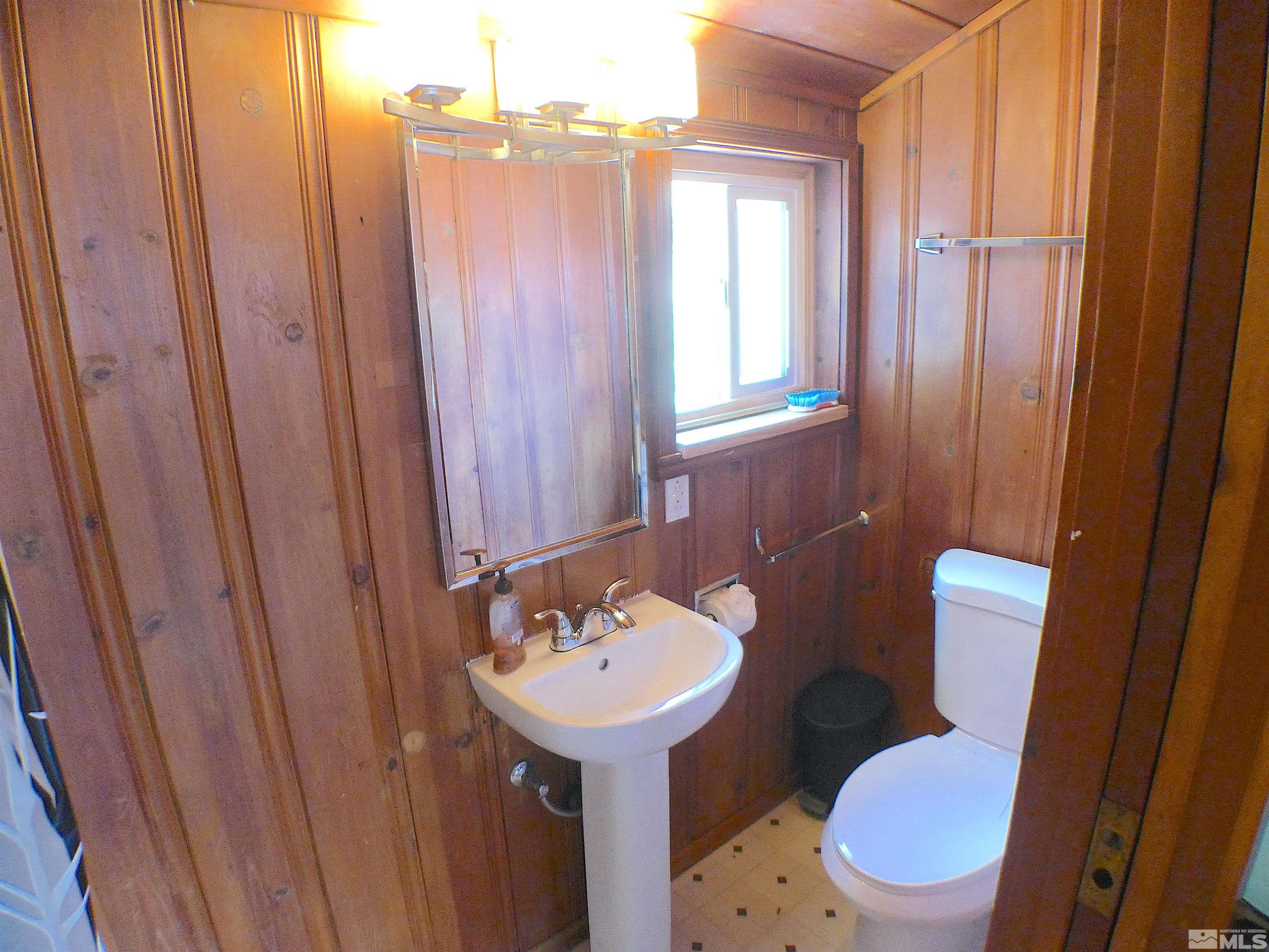 925 Yori Avenue Reno, NV 89502 - Photo 14 of 20 a bathroom with a sink a toilet a mirror and tub