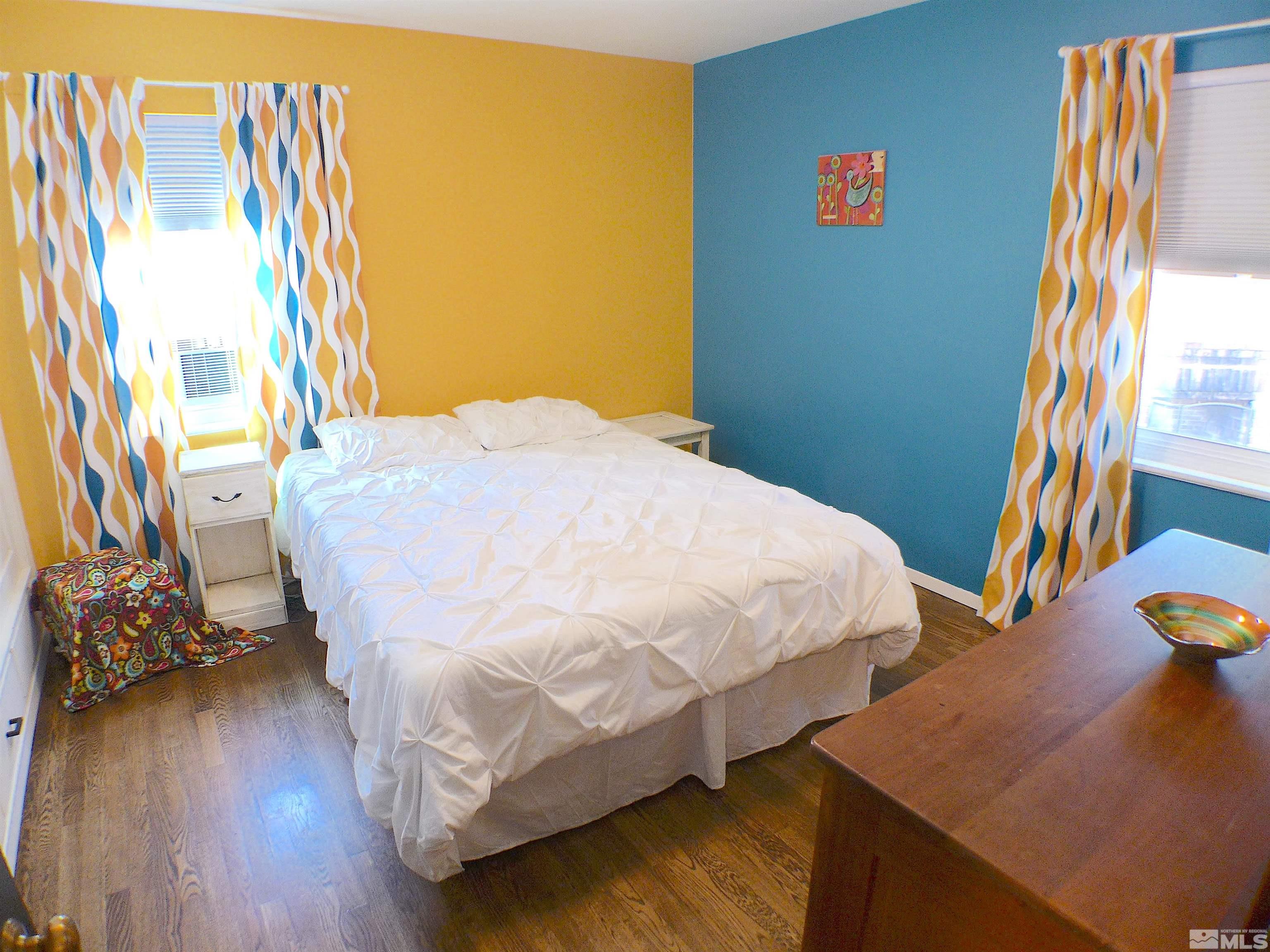 925 Yori Avenue Reno, NV 89502 - Photo 9 of 20 a bedroom with a bed and wooden floor