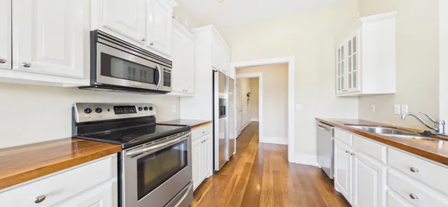 a view of a bedroom with a large window and wooden floor