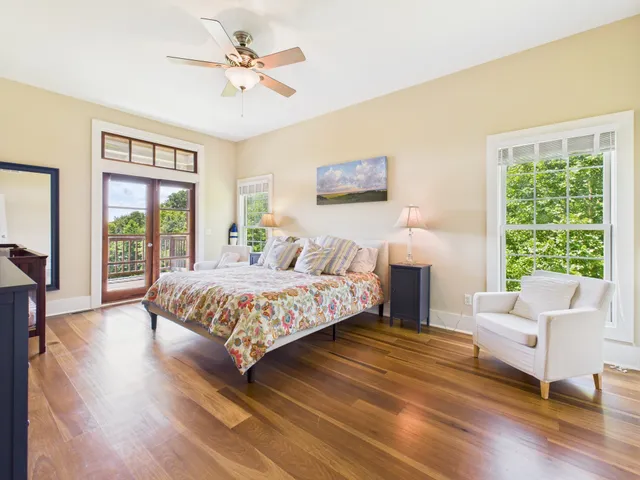 a bedroom with a large window and a bed