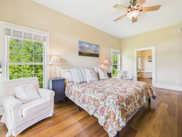 a spacious bedroom with a bed and a chandelier