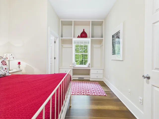 a view of a dining room and livingroom with furniture wooden floor a chandelier